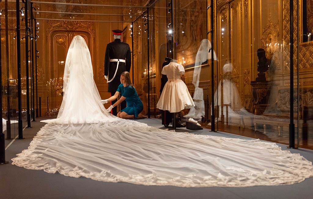 Curator-Caroline-de-Guitaut-makes-final-adjustments-to-A-Royal-Wedding-The-Duke-and-Duchess-of-Sussex-in-the-Grand-Reception-Rm-Windsor-Castle